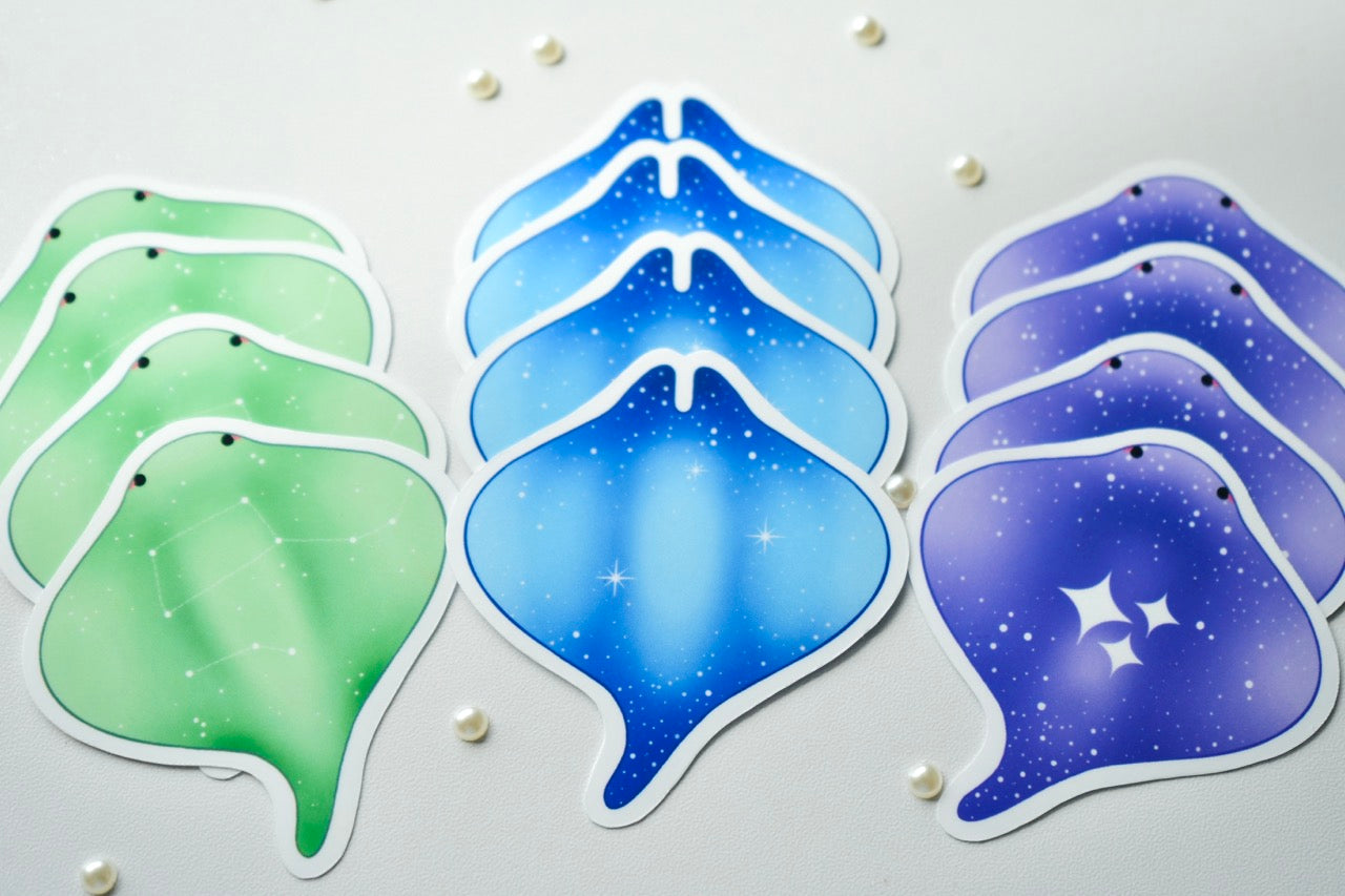 Manta ray stickers in green, blue, and purple by Kimaiisu Studio.